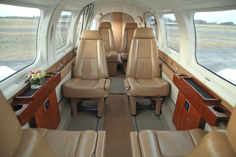 Leather club seating in the cabin of a twin-engine aircraft Coastal Connections flies